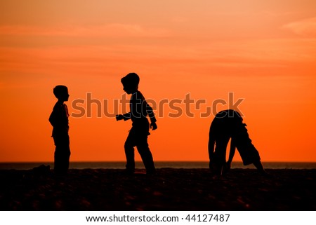Children Playing Football On The Beach